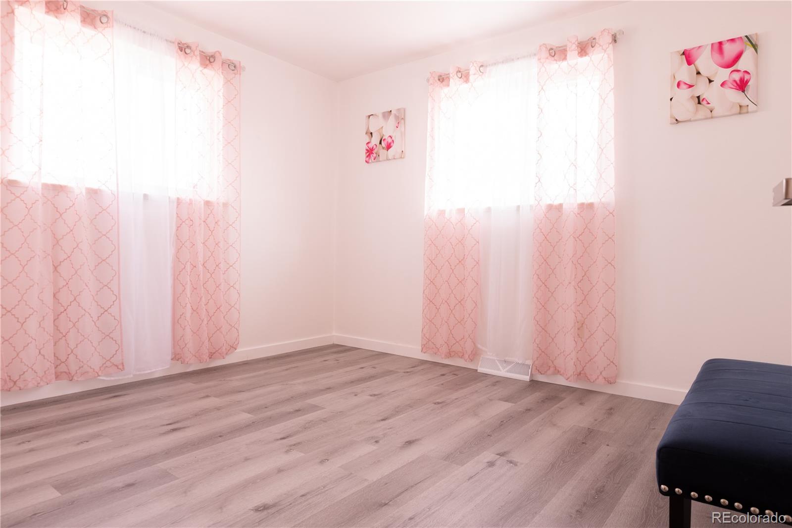 8243 Adams Way Denver, CO 80221 - Photo 16 of 27 a view of a closet with wooden floor