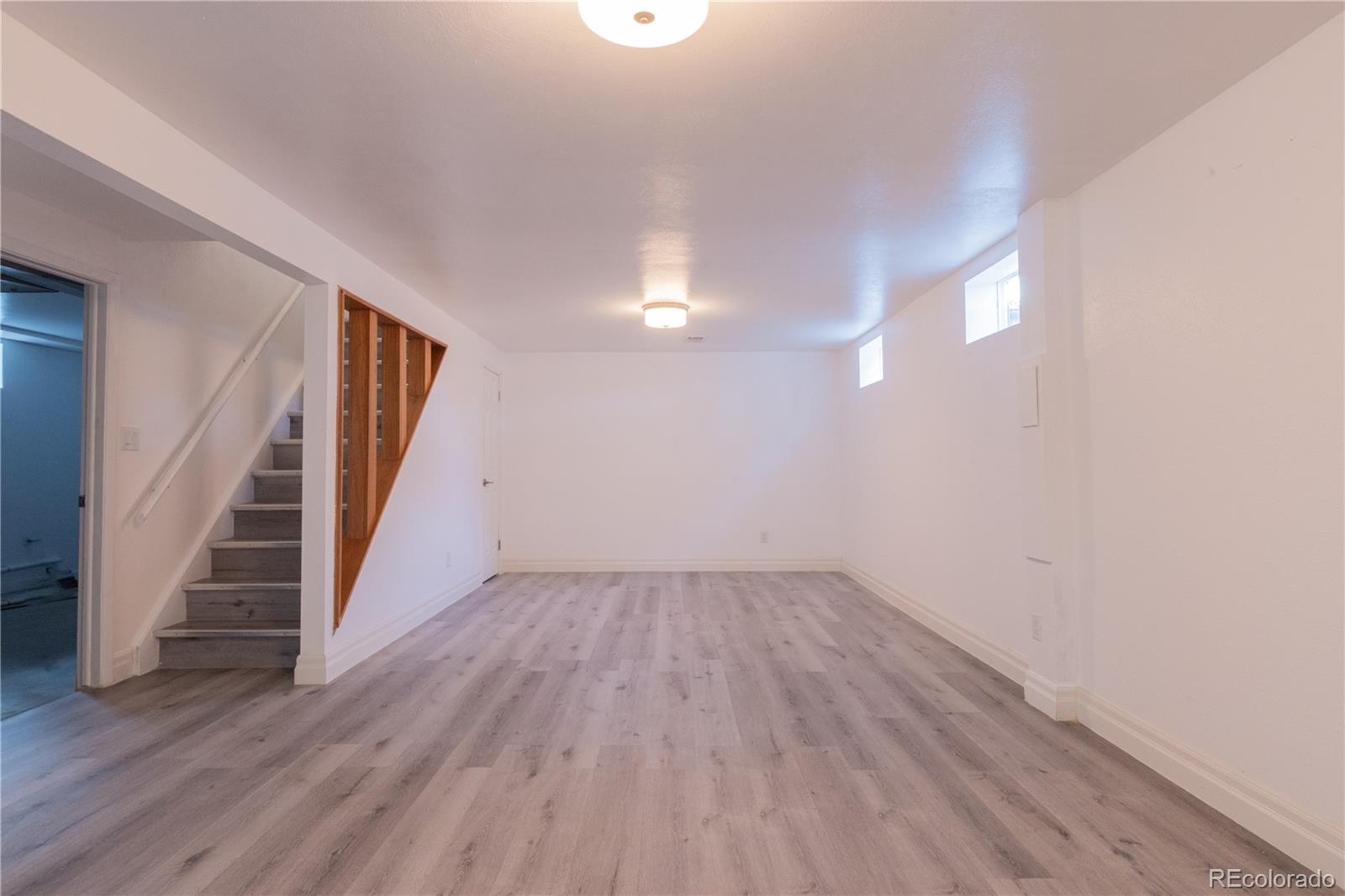 8243 Adams Way Denver, CO 80221 - Photo 19 of 27 wooden floor in an empty room with a window