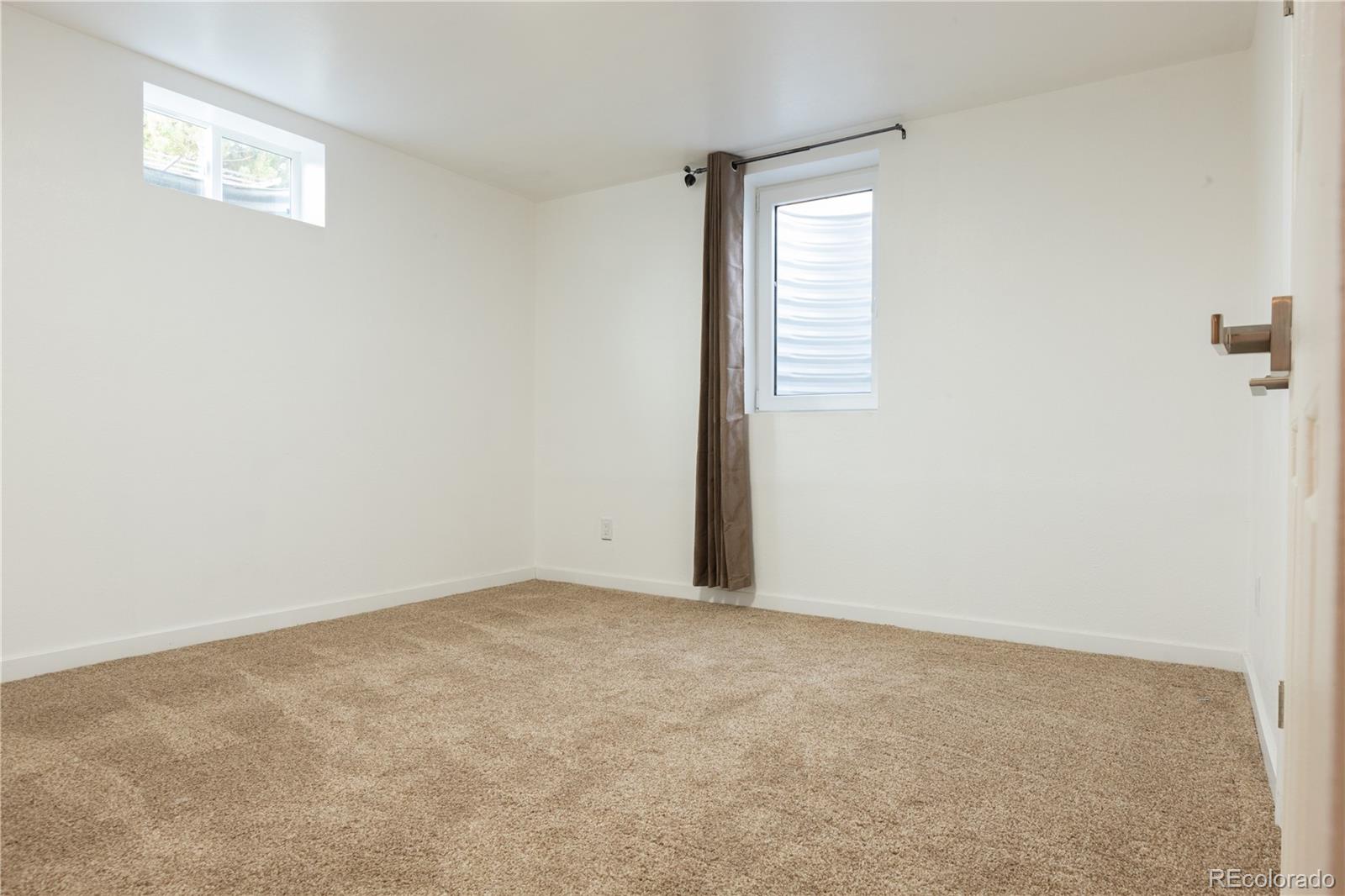 8243 Adams Way Denver, CO 80221 - Photo 22 of 27 an empty room with windows