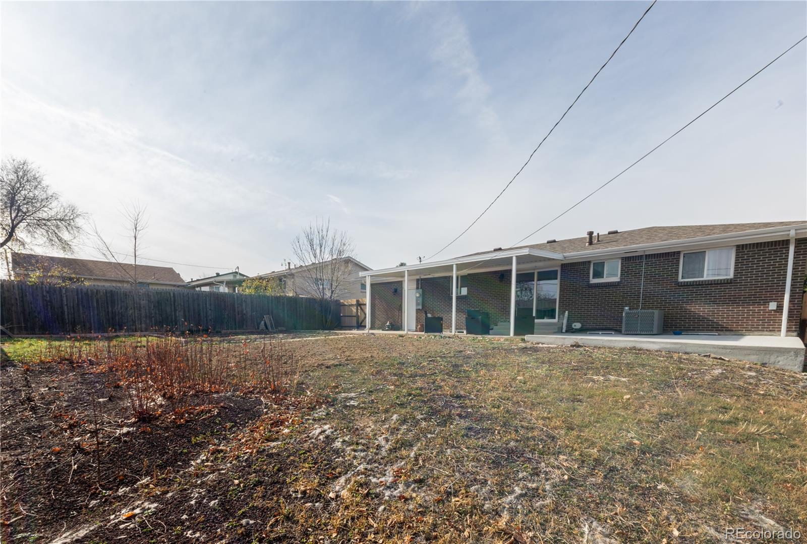 8243 Adams Way Denver, CO 80221 - Photo 27 of 27 a front view of a house with a yard