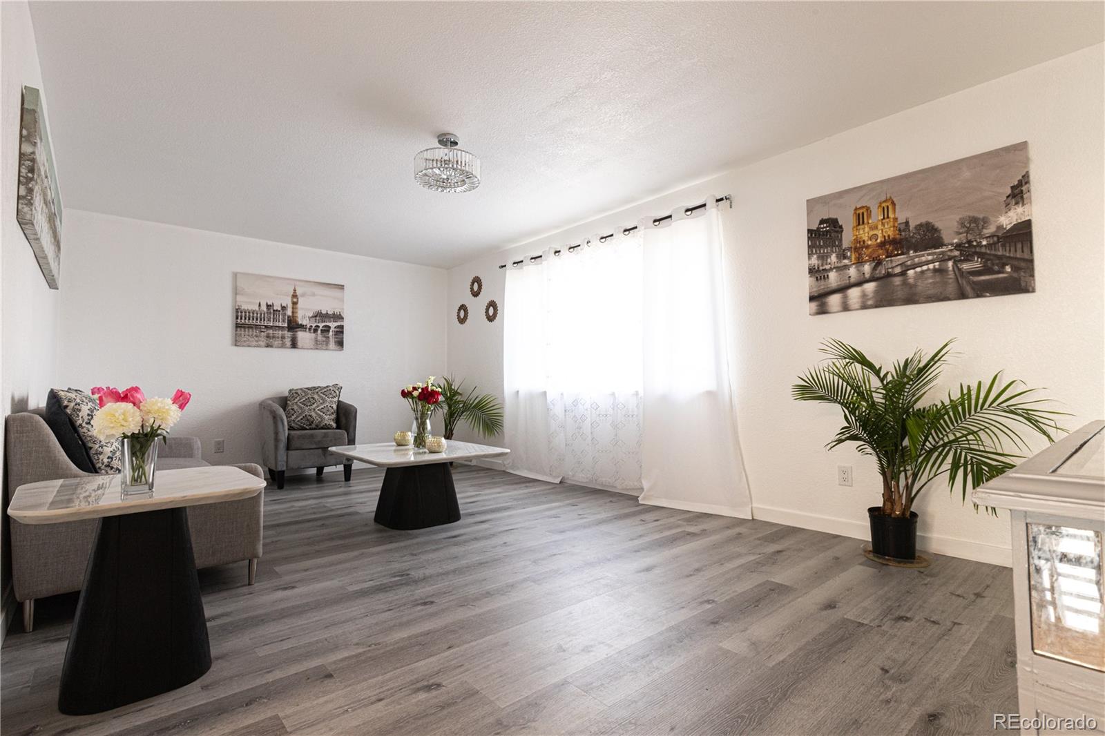 8243 Adams Way Denver, CO 80221 - Photo 3 of 27 a living room with furniture and wooden floor