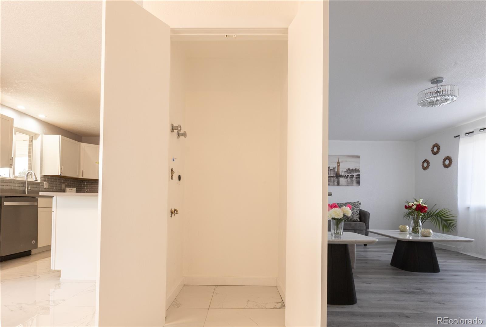 8243 Adams Way Denver, CO 80221 - Photo 4 of 27 a room with a couch and potted plant