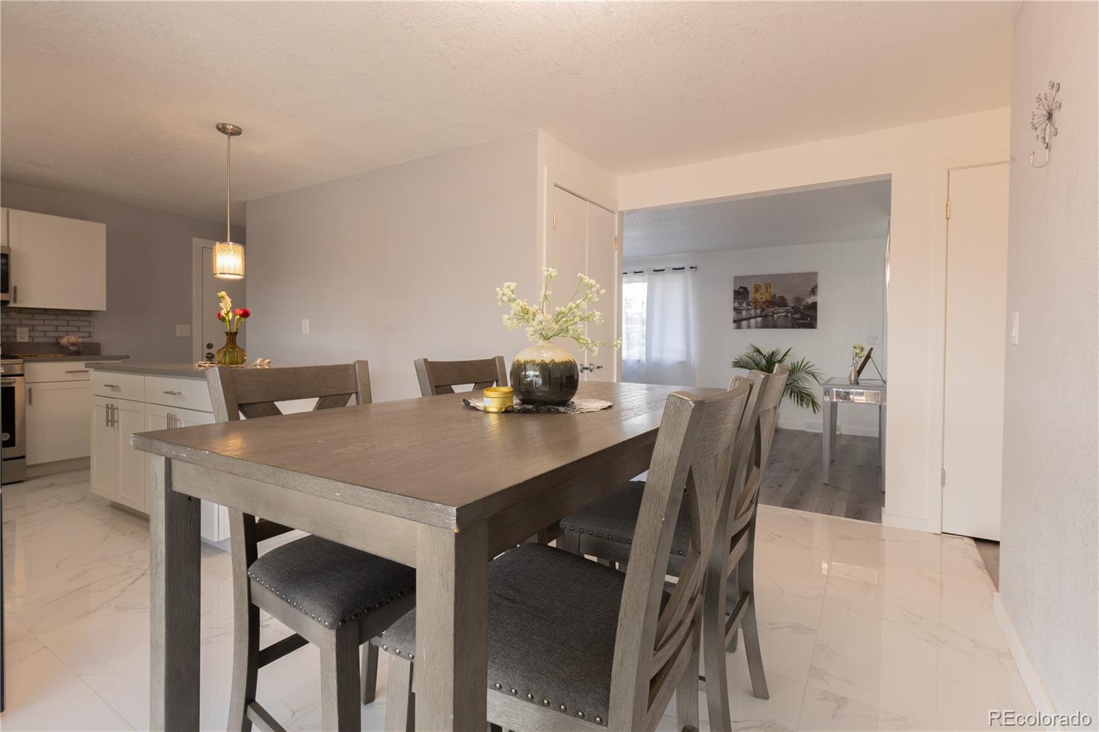 8243 Adams Way Denver, CO 80221 - Photo 8 of 27 a dining room with furniture and window