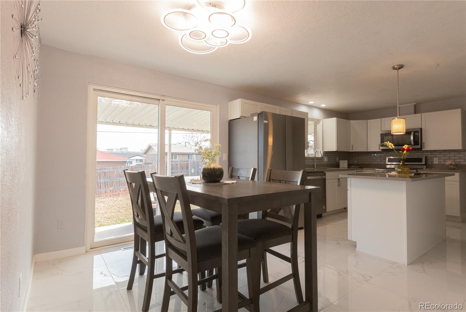8243 Adams Way Denver, CO 80221 - Photo 9 of 27 a view of a dining room with furniture window and wooden floor