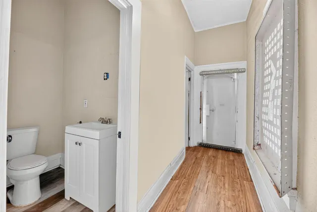 a view of bathroom with a toilet sink and a mirror