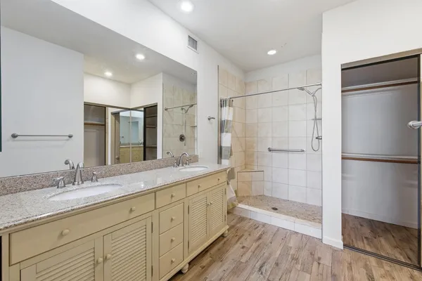 a bathroom with a shower sink and mirror