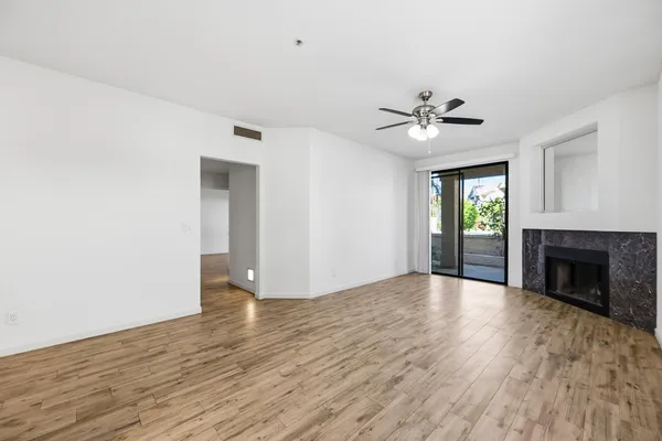 wooden floor in an empty room with a fireplace