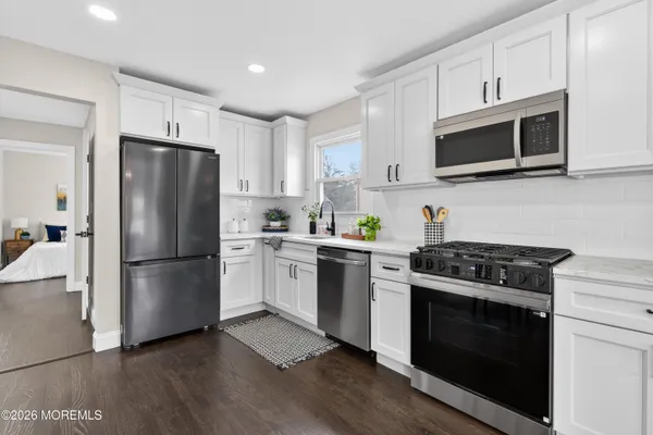 a kitchen with a stove a microwave and refrigerator