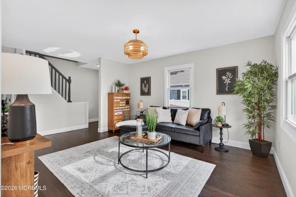 a living room with furniture a potted plant and a fireplace