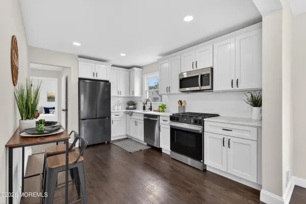 a kitchen with a refrigerator stove and microwave