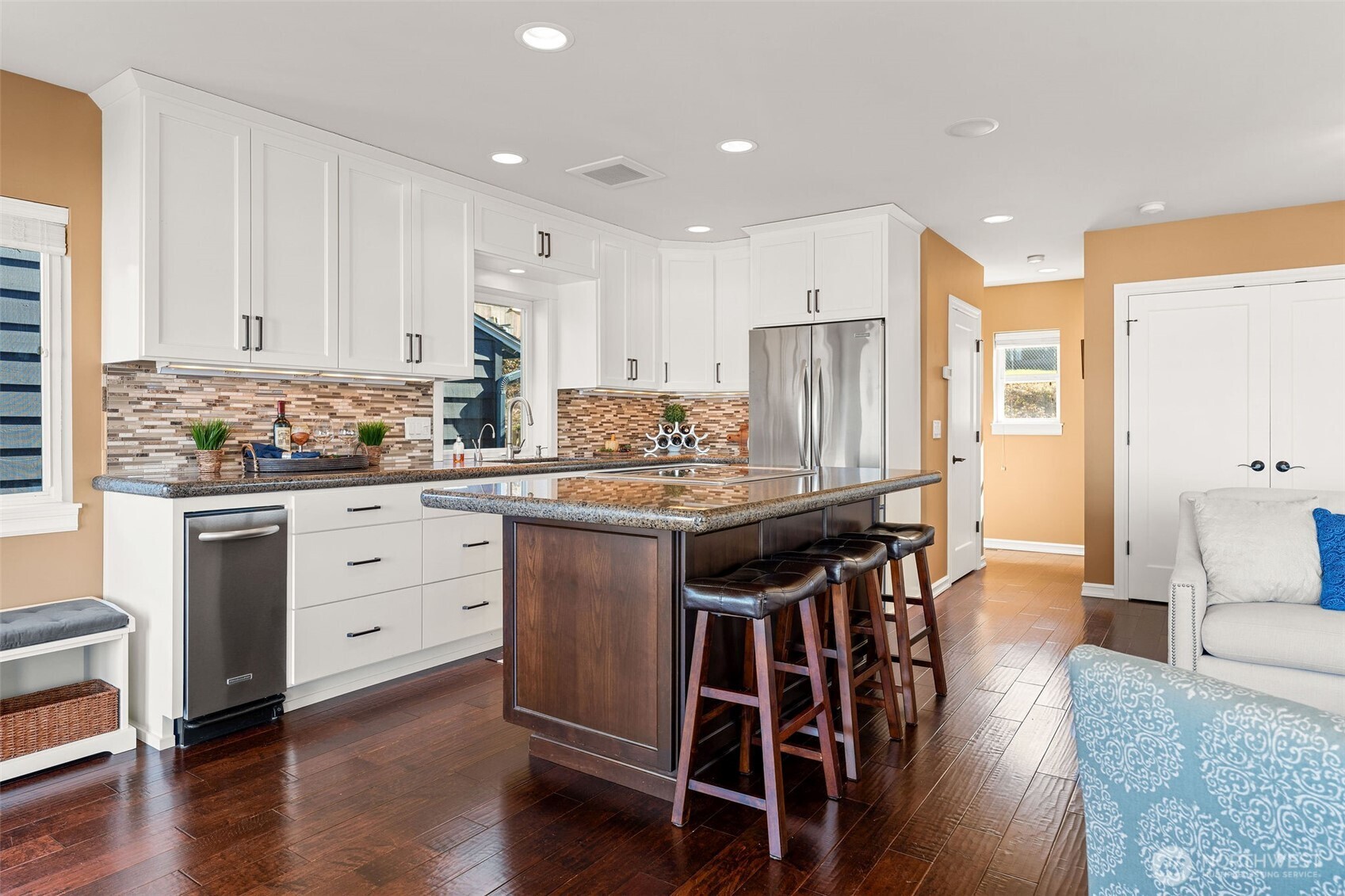 781 Maple Grove Road Camano Island, WA 98282 - Photo 12 of 39 a kitchen with stainless steel appliances kitchen island granite countertop a table chairs sink refrigerator and cabinets