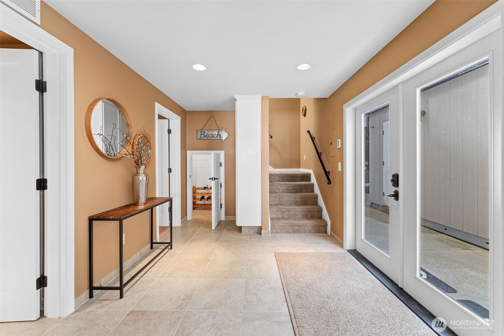 781 Maple Grove Road Camano Island, WA 98282 - Photo 22 of 39 a view of a hallway with entryway wooden floor and front door