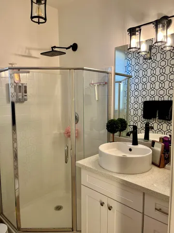 a bathroom with a glass door shower