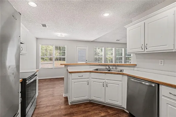 a kitchen with a sink stove and cabinets