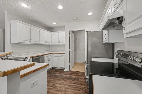 a kitchen with a sink stainless steel appliances and cabinets