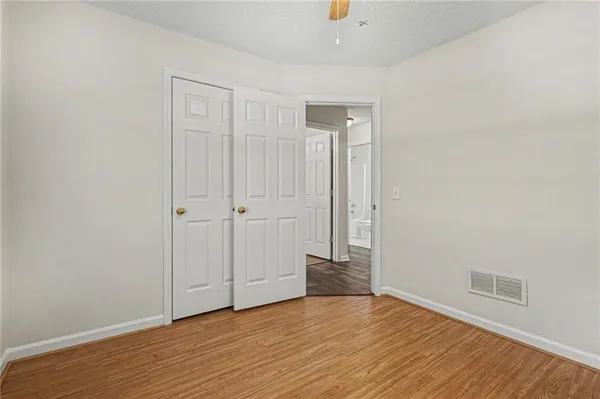 a view of an empty room with wooden floor