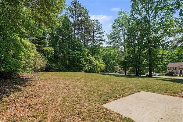 a view of a field with trees in the background