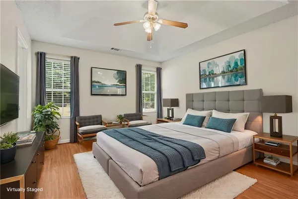 a bedroom with bed and a chandelier