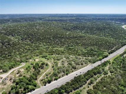 a view of a green field with lots of bushes