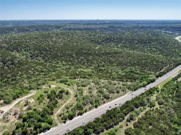 a view of a green field with lots of bushes