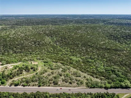 a view of a city with lush green forest