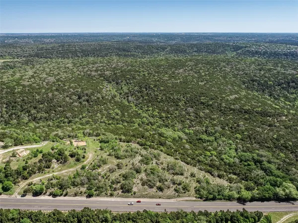 a view of a city with lush green forest