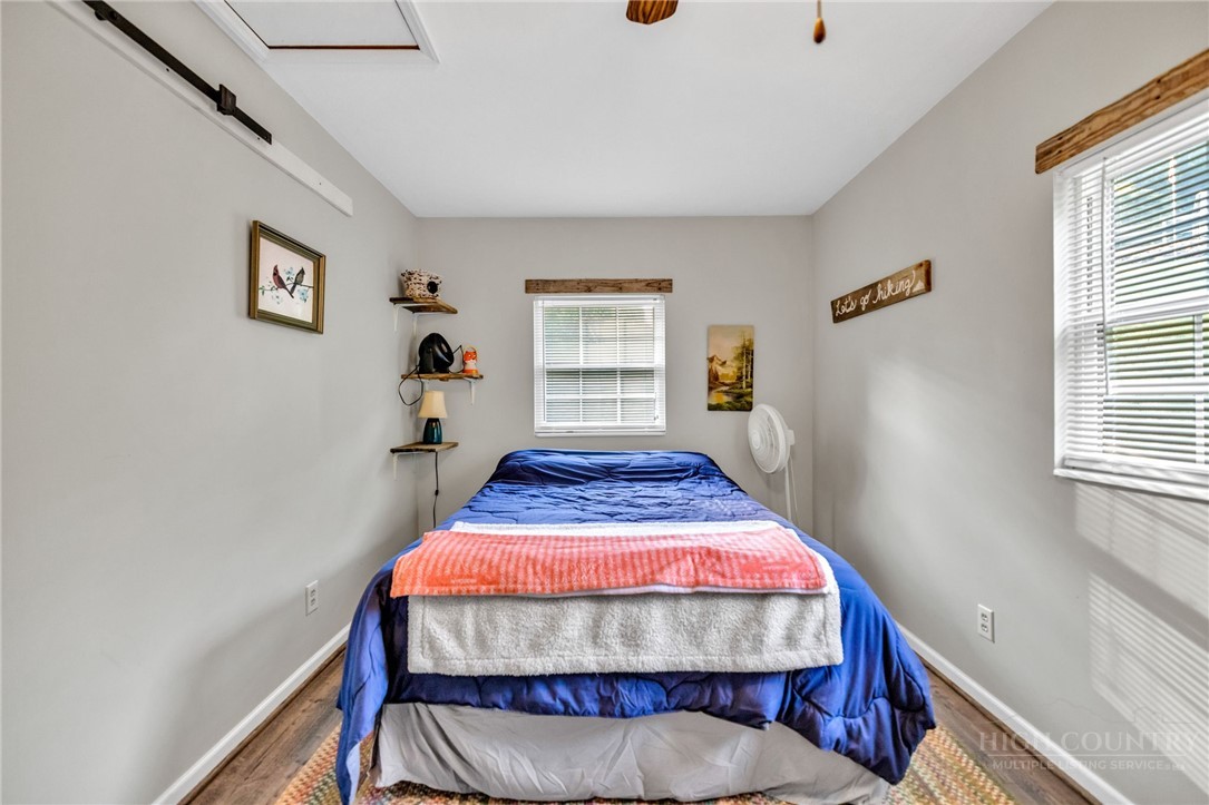 242 Ladd Parson Road Crumpler, NC 28617 - Photo 22 of 36 a bed sitting in a bedroom next to a window