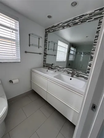 a bathroom with a sink a toilet and a shower