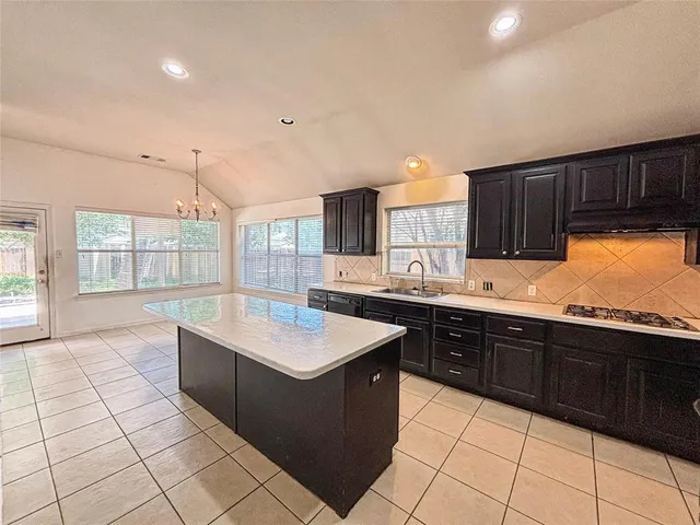 a kitchen with a sink a counter top space and appliances
