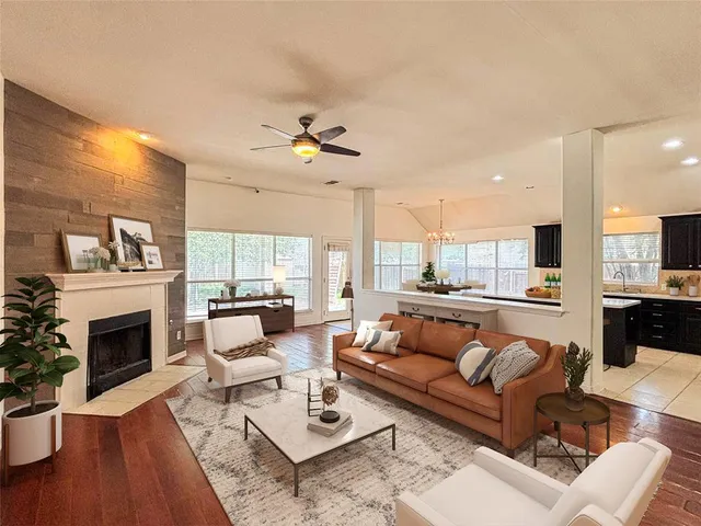 an open kitchen with a sink and chandelier