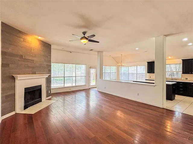 a living room with furniture fireplace and kitchen view