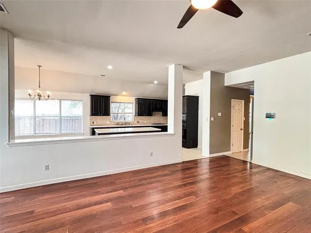 wooden floor fireplace and windows in an empty room