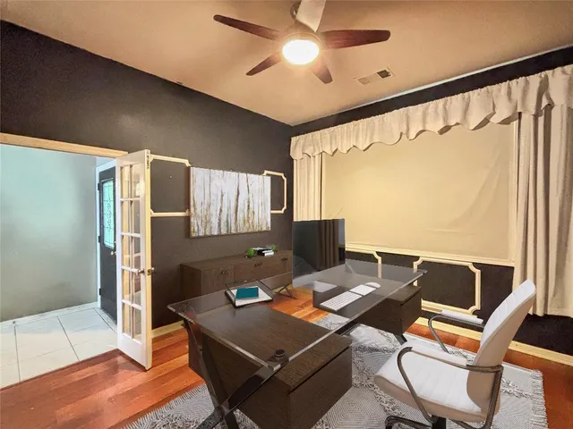 a laptop computer sitting on top of a table and chair