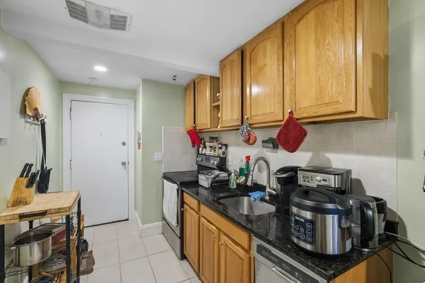 a kitchen with a stove and a refrigerator