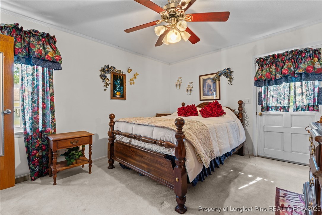255 Sarason Place Vass, NC 28394 - Photo 12 of 50 a bedroom with a bed and a chandelier