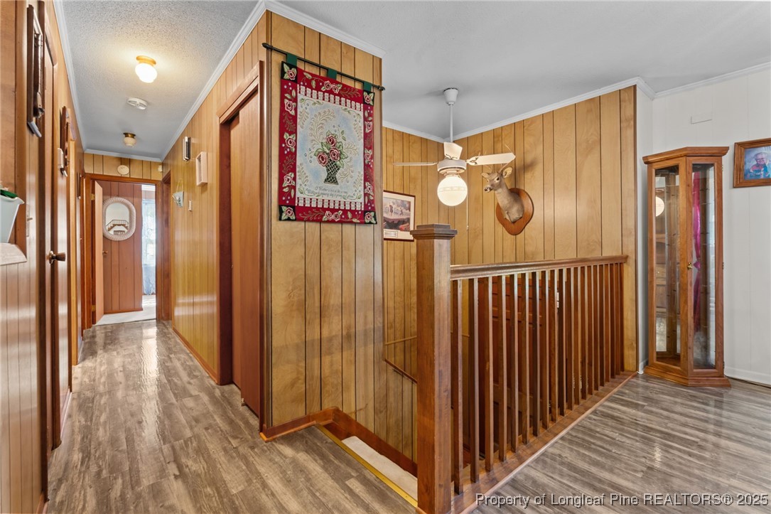 255 Sarason Place Vass, NC 28394 - Photo 19 of 50 a view of a hallway with wooden floor and stairs