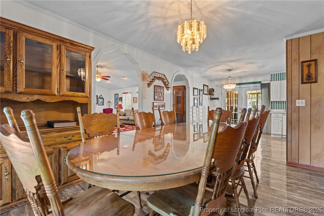 255 Sarason Place Vass, NC 28394 - Photo 23 of 50 a view of a dining room with furniture wooden floor and chandelier