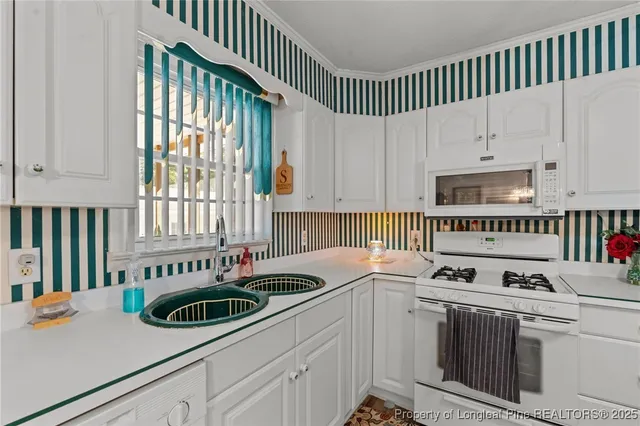 a kitchen that has a sink and a stove