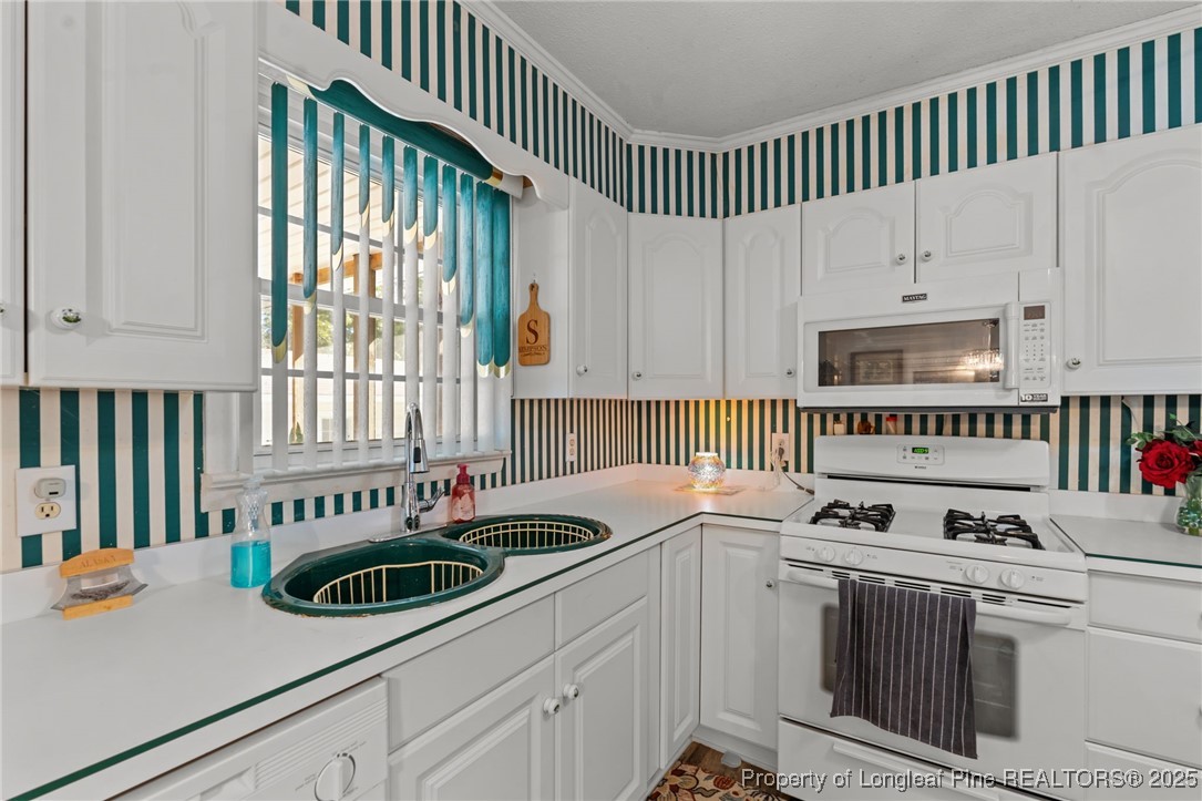 255 Sarason Place Vass, NC 28394 - Photo 26 of 50 a kitchen that has a sink and a stove