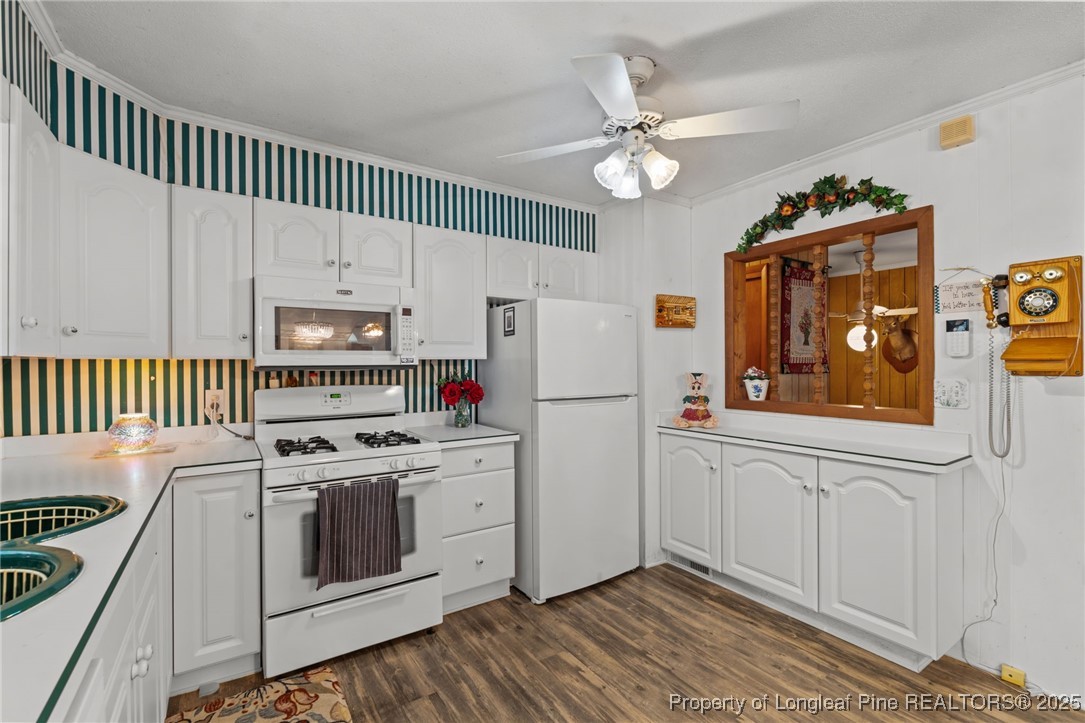 255 Sarason Place Vass, NC 28394 - Photo 27 of 50 a kitchen with stainless steel appliances a white cabinets and a stove top oven