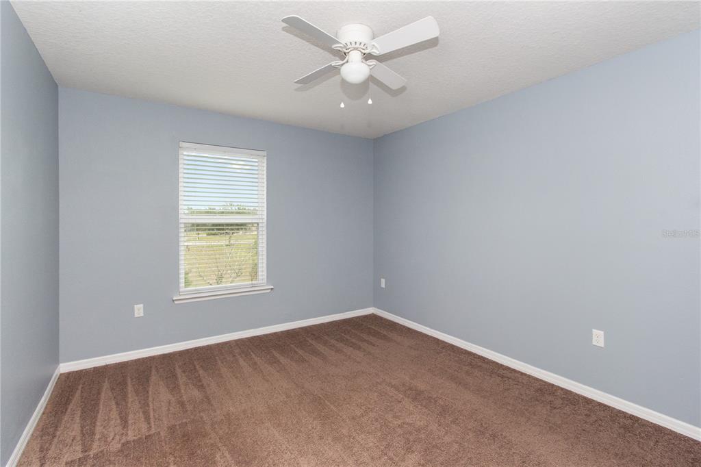13222 Weatherstone Drive Spring Hill, FL 34609 - Photo 13 of 46 an empty room with a window and a ceiling fan