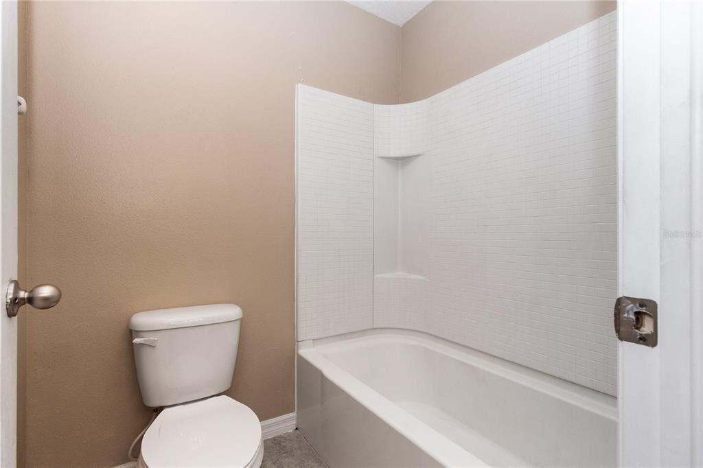 13222 Weatherstone Drive Spring Hill, FL 34609 - Photo 18 of 46 a white toilet sitting next to a white sink