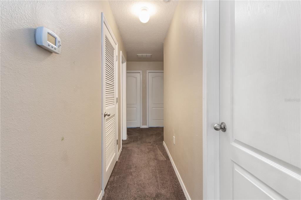 13222 Weatherstone Drive Spring Hill, FL 34609 - Photo 20 of 46 a view of a hallway with a white walls