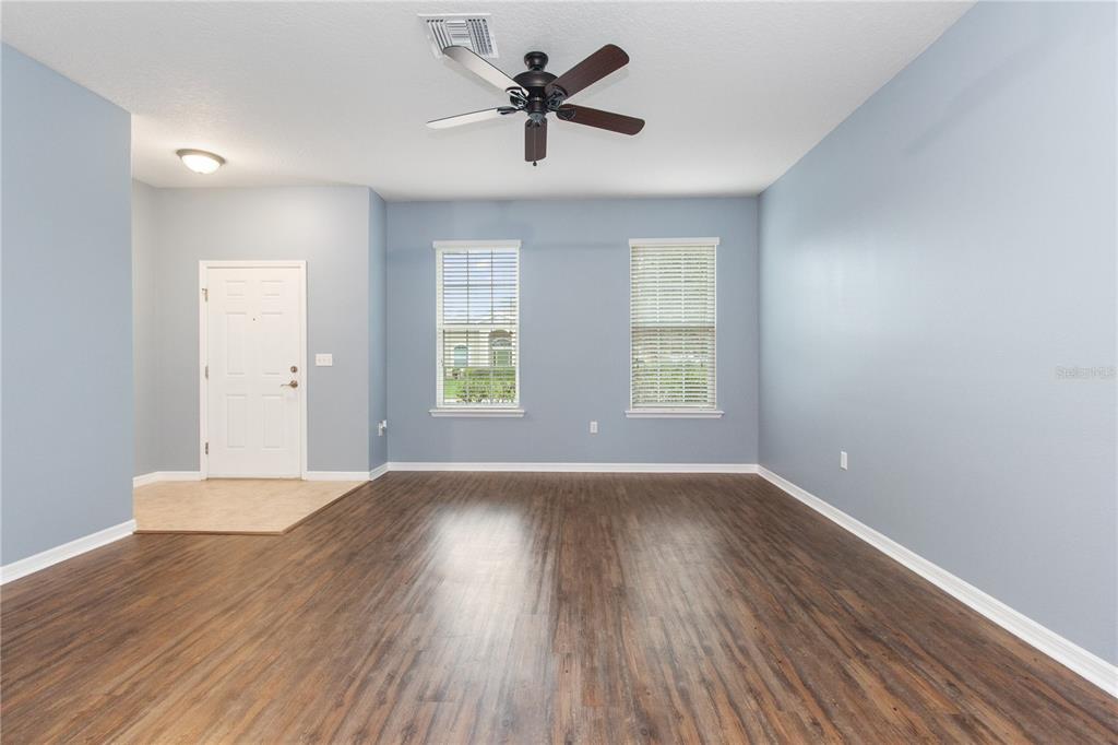 13222 Weatherstone Drive Spring Hill, FL 34609 - Photo 22 of 46 an empty room with wooden floor and windows