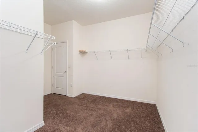 a kitchen with stainless steel appliances granite countertop a refrigerator a sink a stove a washer dryer and a refrigerator