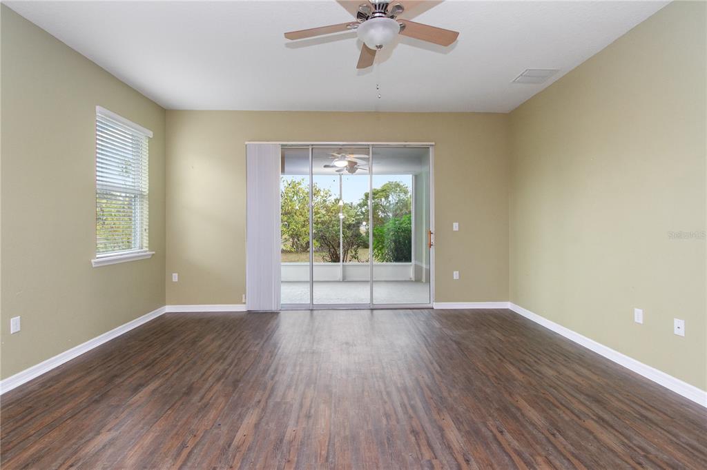 13222 Weatherstone Drive Spring Hill, FL 34609 - Photo 36 of 46 a view of an empty room with a window and wooden floor