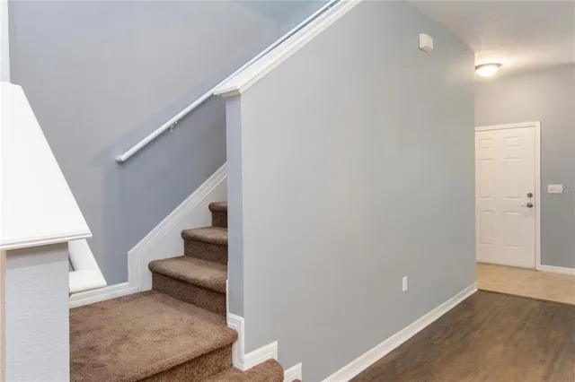 an aerial view of a house with a yard and lake view