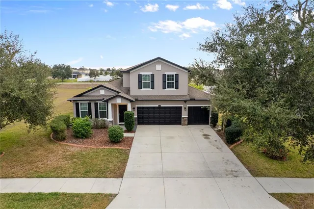 a aerial view of a house next to a yard
