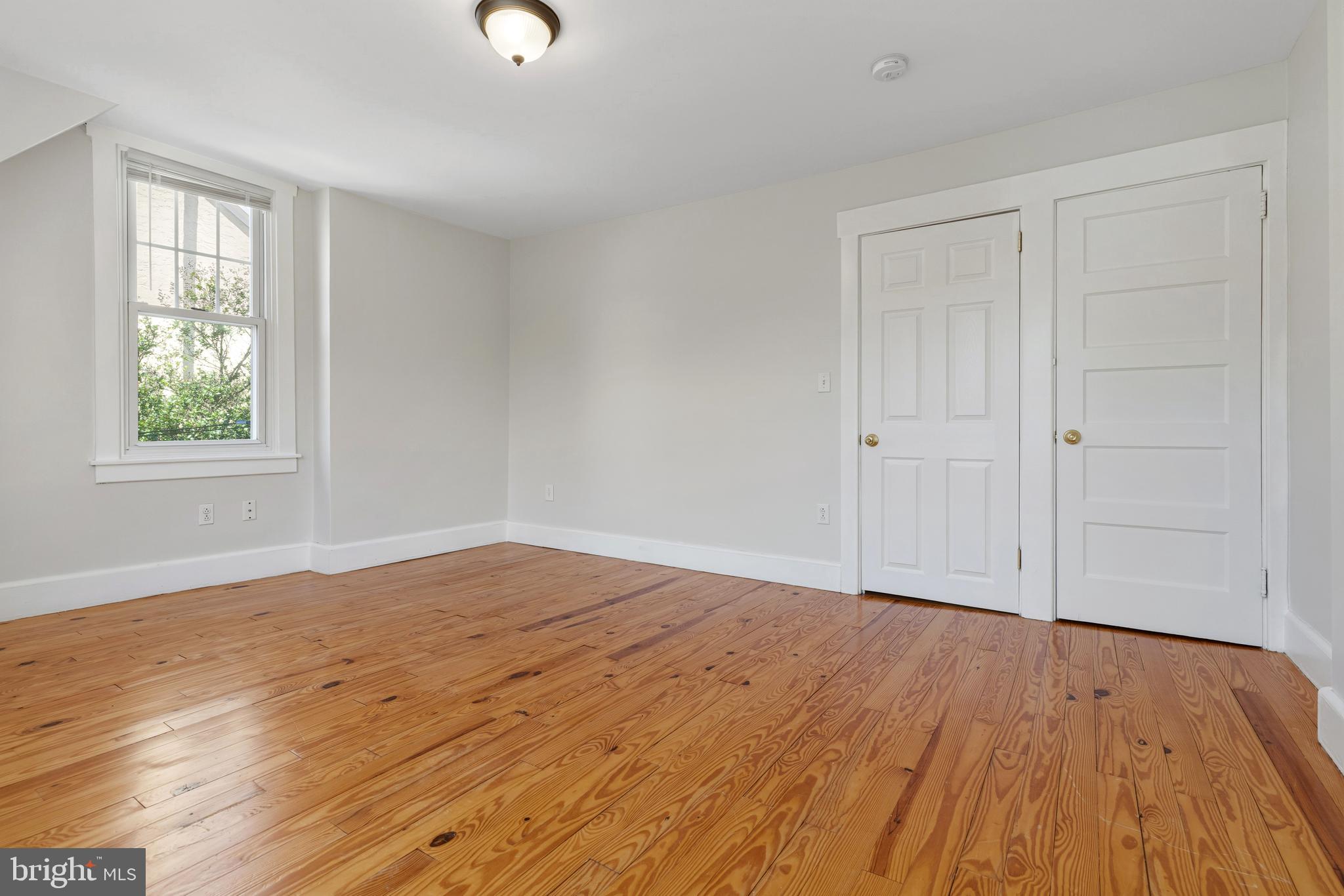 229 Wayne Avenue Narberth, PA 19072 - Photo 22 of 35 wooden floor in an empty room with a window
