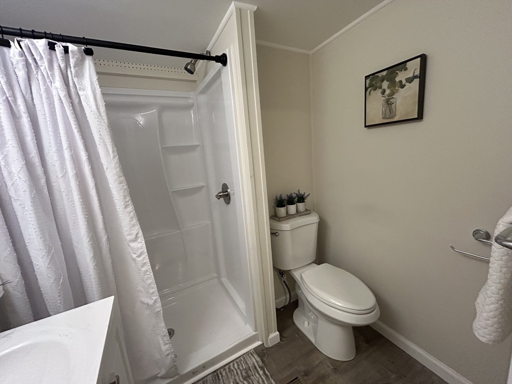 229 Miller Street, Unit D6 Ludlow, MA 01056 - Photo 11 of 24 a white toilet sitting next to a bath tub